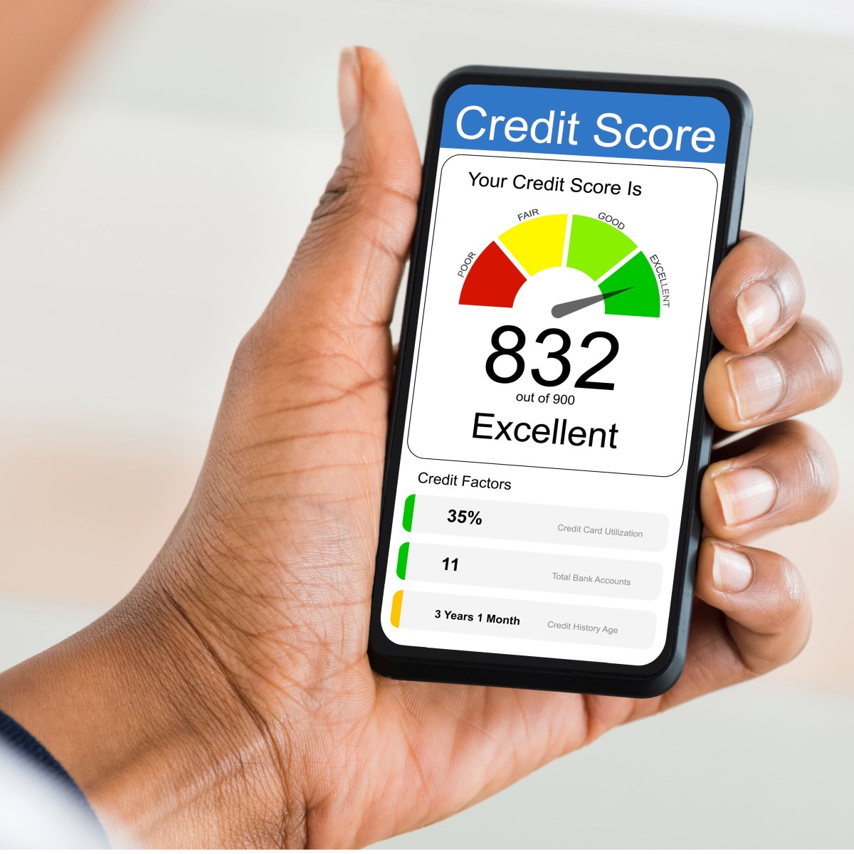 hand holding a cell phone with a high credit score displayed