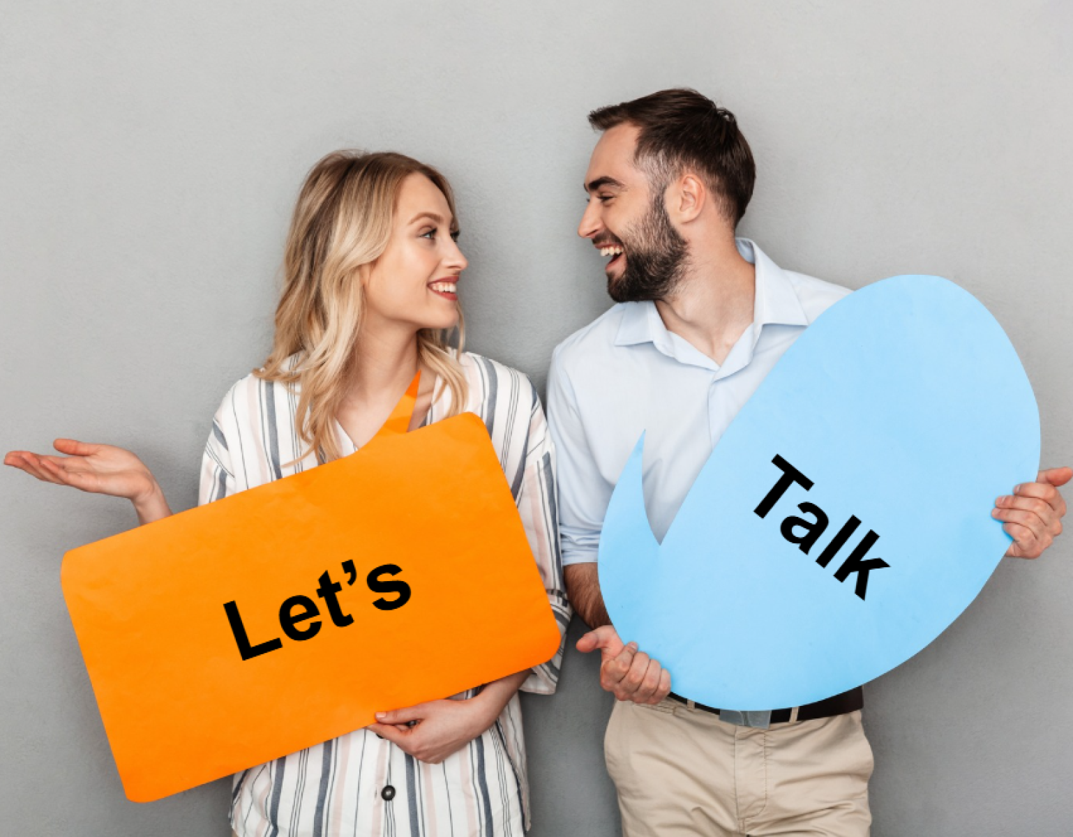 Couple holding up signs that say let's talk.